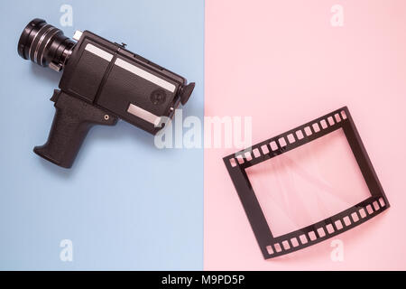 Retro camcorder and photo frame isolated on colorful pastel background minimal creative concept. Stock Photo