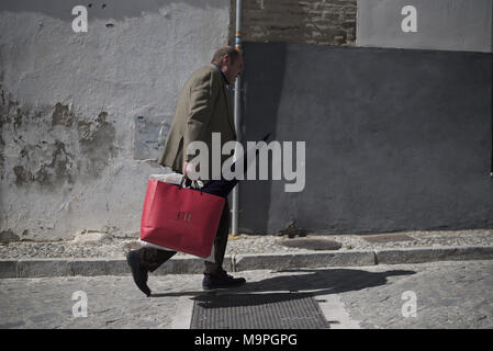 Granada, Granada, Spain. 27th Mar, 2018. A man carries his penitent hat on his way to the church on Holy Tuesday in Granada.Every year thousands of christians believers celebrates the Holy Week of Easter with the crucifixion and resurrection of Jesus Christ. Credit: Carlos Gil/SOPA Images/ZUMA Wire/Alamy Live News Stock Photo