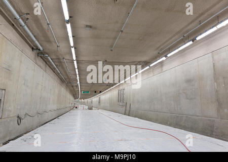 Seattle, Washington, USA. 27th Mar, 2018. The lower deck of the SR 99 Tunnel under construction. The Alaskan Way Viaduct Replacement Program’s road decks have been completed and the tunnel’s operational and safety systems are currently being installed. The bored road tunnel is replacing the Alaskan Way Viaduct and will carry State Route 99 under downtown Seattle from the SODO neighborhood to South Lake Union. Credit: Paul Christian Gordon/Alamy Live News Stock Photo