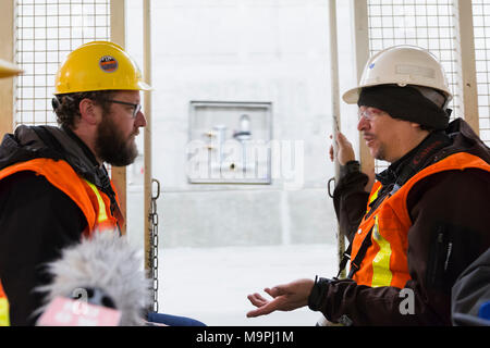 Seattle, Washington, USA. 27th Mar, 2018. Members of the media in discussion during a tour of the SR 99 Tunnel. The Alaskan Way Viaduct Replacement Program’s road decks have been completed and the tunnel’s operational and safety systems are currently being installed. The bored road tunnel is replacing the Alaskan Way Viaduct and will carry State Route 99 under downtown Seattle from the SODO neighborhood to South Lake Union. Credit: Paul Christian Gordon/Alamy Live News Stock Photo