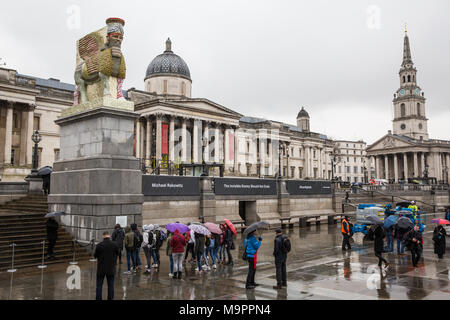London, UK. 28th March, 2018. Michael Rakowitz’s ‘The Invisible Enemy Should Not Exist’ has been unveiled on the Fourth Plinth in Trafalgar Square. A life-size reproduction of one of the large stone statues of a lamassu (a winged bull with a human face) which guarded the gates of the ancient city of Nineveh in Iraq until destroyed by ISIS, it was armoured with 10,500 tin cans used for date syrup. It has been positioned to face towards the Foreign Office, Parliament and the Middle East. Credit: Mark Kerrison/Alamy Live News Stock Photo