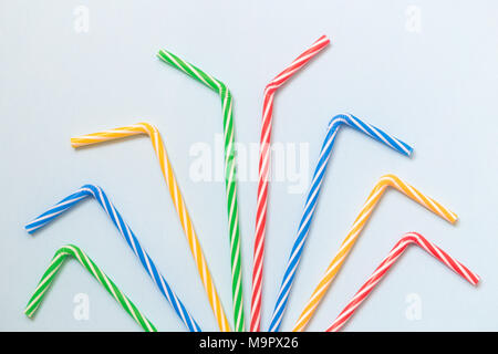 Colorful drinking straws against pastel blue background minimal party creative concept. Stock Photo