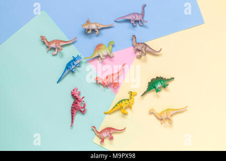 Collection of dinosaurs toys on colorful pastel background minimal creative concept. Stock Photo