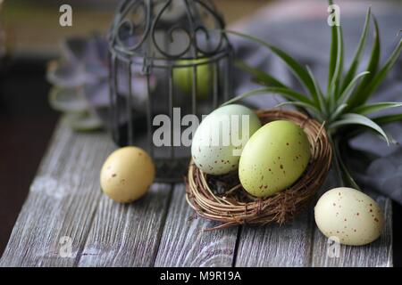 Colorful Easter eggs on wooden table Stock Photo