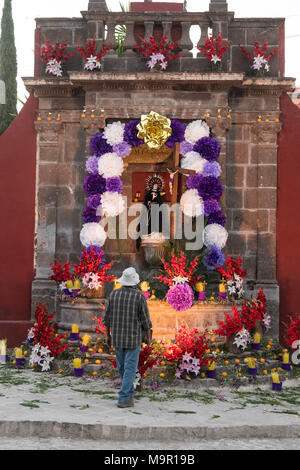 A Mexican man prepares a community altar celebrating El Viernes de Dolores during Holy Week at the Aldama fountain March 23, 2018 in San Miguel de Allende, Mexico. The event honors the sorrow of the Virgin Mary for the death of her son and is an annual tradition in central Mexico. Stock Photo