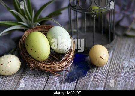Colorful Easter eggs on wooden table Stock Photo
