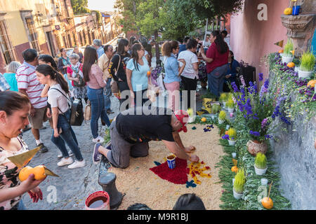 A Mexican man prepares a community altar celebrating El Viernes de Dolores during Holy Week March 23, 2018 in San Miguel de Allende, Mexico. The event honors the sorrow of the Virgin Mary for the death of her son and is an annual tradition in central Mexico. Stock Photo