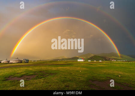 Double rainbow above nomad yurts in a green landscape, Mongolia Stock Photo
