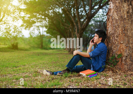 man talking on mobile phone in the park Stock Photo