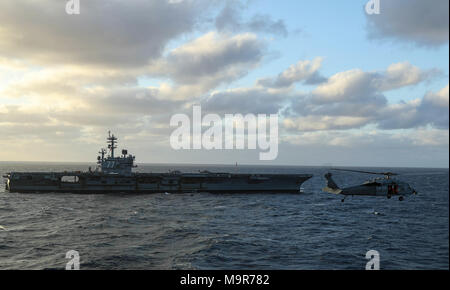 180326-N-FQ836-0741 ATLANTIC OCEAN (March 26, 2018) The Nimitz-class aircraft carrier USS George H.W. Bush (CVN 77) steams alongside the Nimitz-class aircraft carrier USS Abraham Lincoln (CVN 72) during an underway ammunition onload. (U.S. Navy photo by Mass Communication Specialist 3rd Class Jeff Sherman/Released) Stock Photo