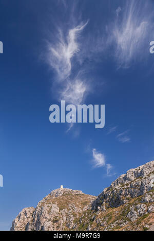 Watchtower and cirrus clouds at Formentor, Mallorca, Spain on a sunny summer's day Stock Photo