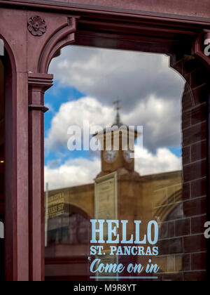 KINGS CROSS STATION, LONDON:  The Kings Cross Clock Tower reflected  in a window of St Pancras Station Stock Photo