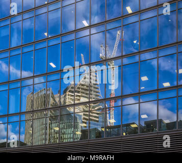 LONDON, UK - MARCH 08, 2018:  Office Towers under construction reflected in windows of building Stock Photo