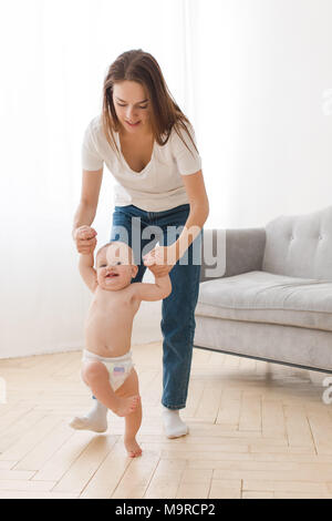 Mother learning child to walk Stock Photo
