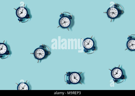 Flat lay retro beautiful new alarm clock on blue color background ...