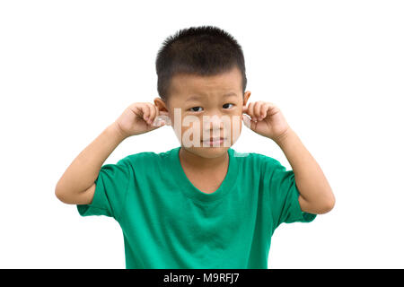 Asian child covering ears with hands. Portrait of young boy isolated on white background. Stock Photo