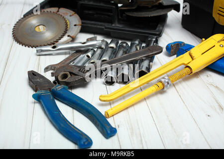 On a white wooden table there are various tools for repair of damages. Stock Photo
