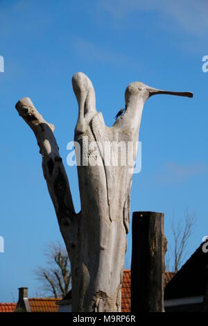 a tree trunk in which animals are cut out Stock Photo