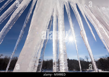 Large icicles hanging in the midday sunshine. Stock Photo