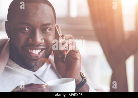 Portrait of positive black man looking straight at camera Stock Photo