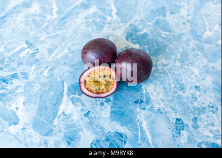 Passion fruit on blue background. Methods of cutting exotic fruits Stock Photo