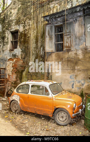 Old style Fiat 500 in the orange and white colours on the streets of Bangkok in Thailand. Stock Photo