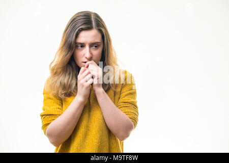 A vulnerable at risk, young Caucasian woman girl  alone, looking sad unhappy depressed lonely downcast emotionally abused nervous -    on  a white background, UK Stock Photo