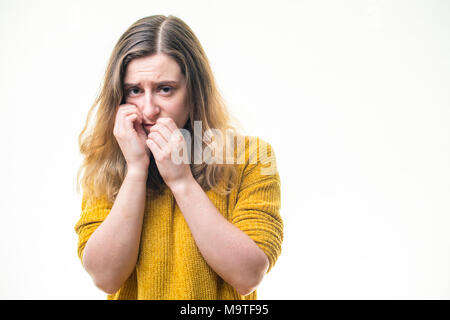 A vulnerable at risk, young Caucasian woman girl  alone, looking sad unhappy depressed lonely downcast emotionally abused nervous -    on  a white background, UK Stock Photo