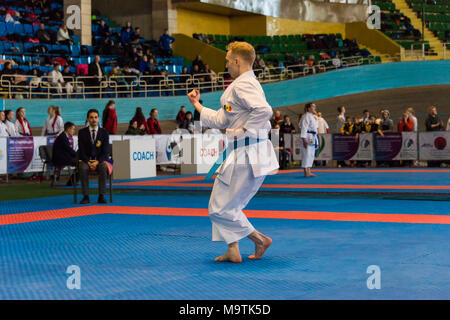 Lviv , Ukraine - March 25, 2018: International open karate cup . Unknown athlete performs during the competition  in the sports complex of the army,   Stock Photo