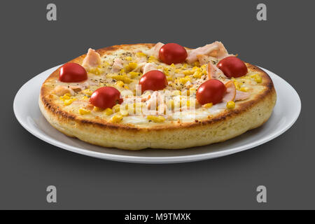 Italian pizza with cherry tomatoes, ham and sweet corn Stock Photo