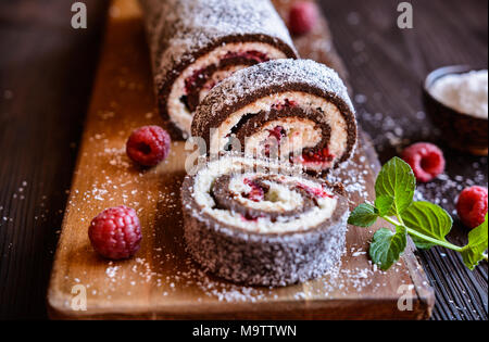 No bake chocolate roll cake filled with coconut cream and raspberry Stock Photo