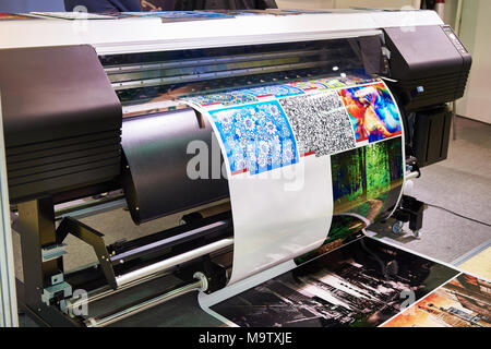 Big rolling wide plotter printer in work Stock Photo