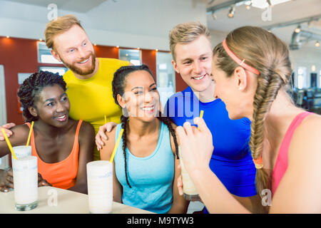 Multi-ethnic group of cheerful friends drinking protein shakes Stock Photo