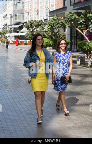 Two happy female tourists walking in dubai Stock Photo