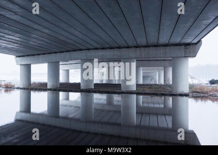 Reflection in the cold water under the A5 highway bridge in Amsterdam the Netherlands. Stock Photo