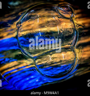 Psychedelic colours bubbles over coloured glass. Stock Photo