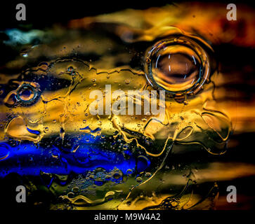 Psychedelic colours bubbles over coloured glass. Stock Photo