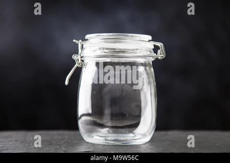 Glass jar on dark background Stock Photo