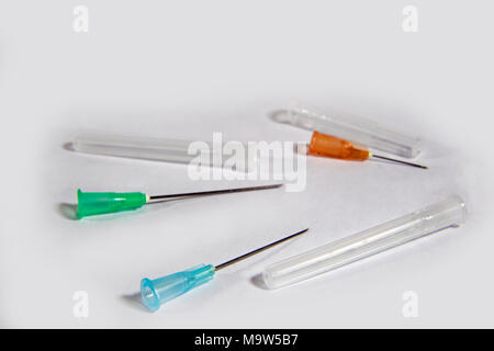 A studio shot of a range of hypodermic syringe needles on a white background. Stock Photo