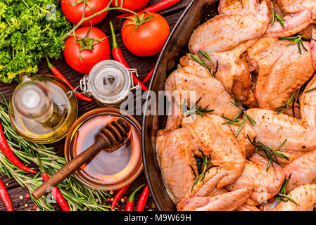 Chickens wings covered in honey, vegetables Stock Photo