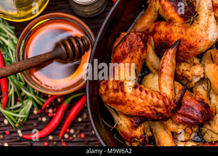 Baked chickens wings covered in honey, vegetables Stock Photo