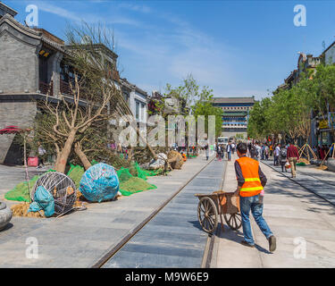 Planting trees in Qianmen Street, with Zhengyang Gate Jianlou in the background. Beijing, China Stock Photo