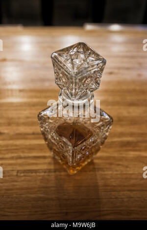 Antique whiskey bottle on top of bar counter. Stock Photo