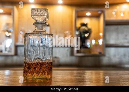 Antique whiskey bottle on top of bar counter. Stock Photo