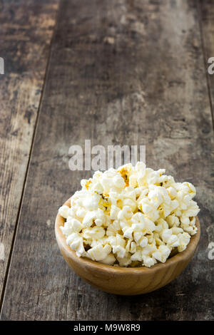 Popcorn in bowl on wooden table. Stock Photo