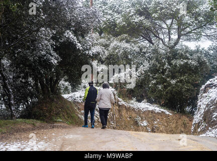 Senior couple walking on snowy mountain,Barcelona,Catalonia,Spain,Europe. Stock Photo