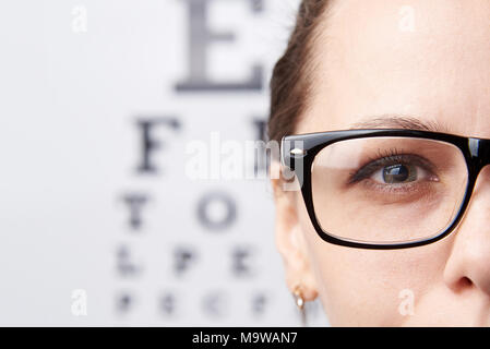 Girl in glasses on the background of a table for vision Stock Photo