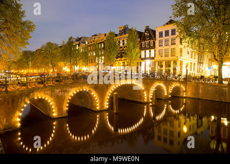 Amsterdam, Netherlands - April 20, 2017: One of the famous canal of Amsterdam, the Netherlands at dusk. Stock Photo