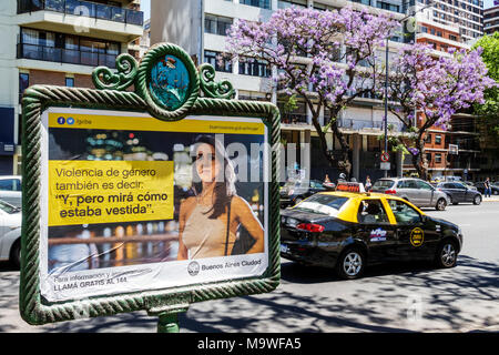 Buenos Aires Argentina,Palermo,Avenida Presidente Figueroa Alcorta,street avenue,jacaranda trees,traffic,taxi,car cars,poster,domestic abuse,Spanish l Stock Photo