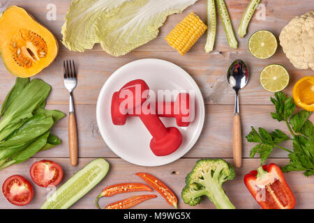 Food and sheet of paper with a diet plan on a dark wooden table. Concept of diet and healthy lifestyle. Stock Photo